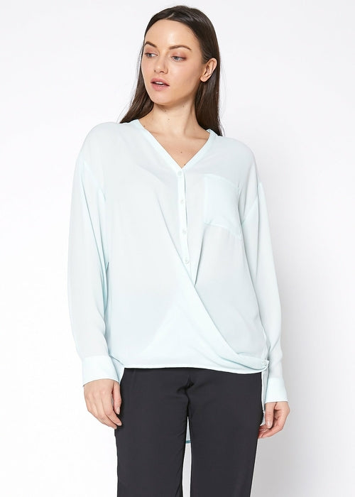 Lemon Hera V-neck wrap hem blouse in peppermint green, showcasing the stylish neckline and flowy fabric detail.
