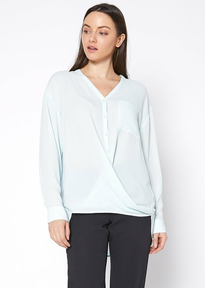 Lemon Hera V-neck wrap hem blouse in peppermint green, showcasing the stylish neckline and flowy fabric detail.