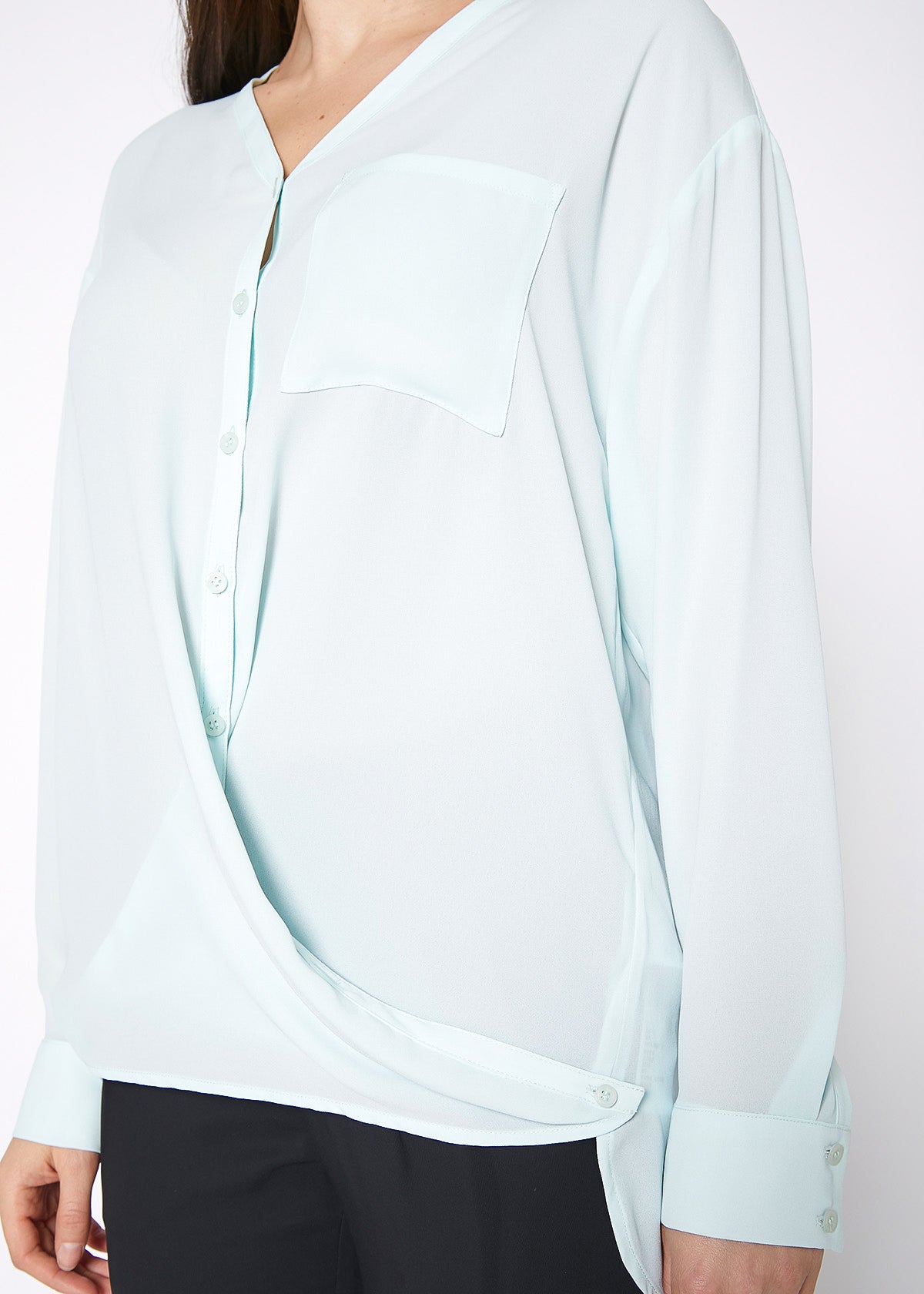 Lemon Hera V-neck wrap hem blouse in peppermint green, featuring a stylish V-neck and flowy long sleeves.