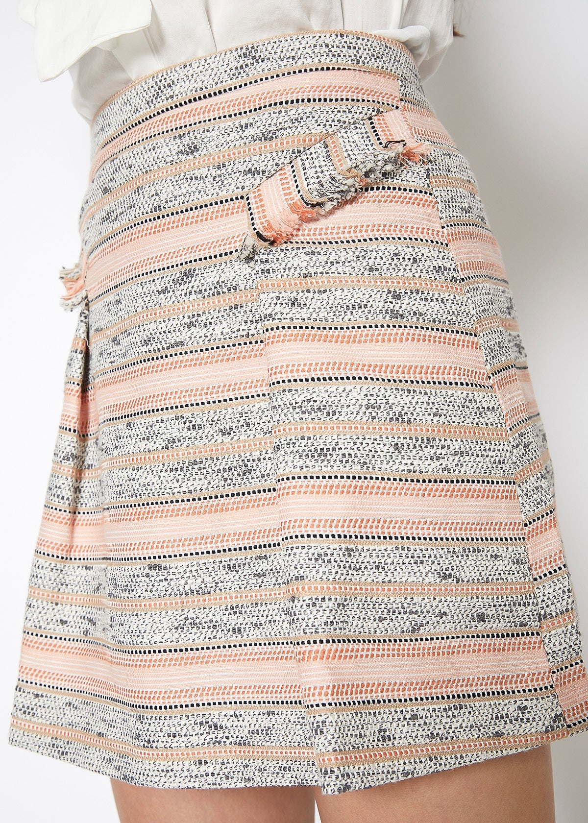 Pink striped tweed mini skirt by Lemon Hera, showing close-up of textured fabric and stylish high waist fit.