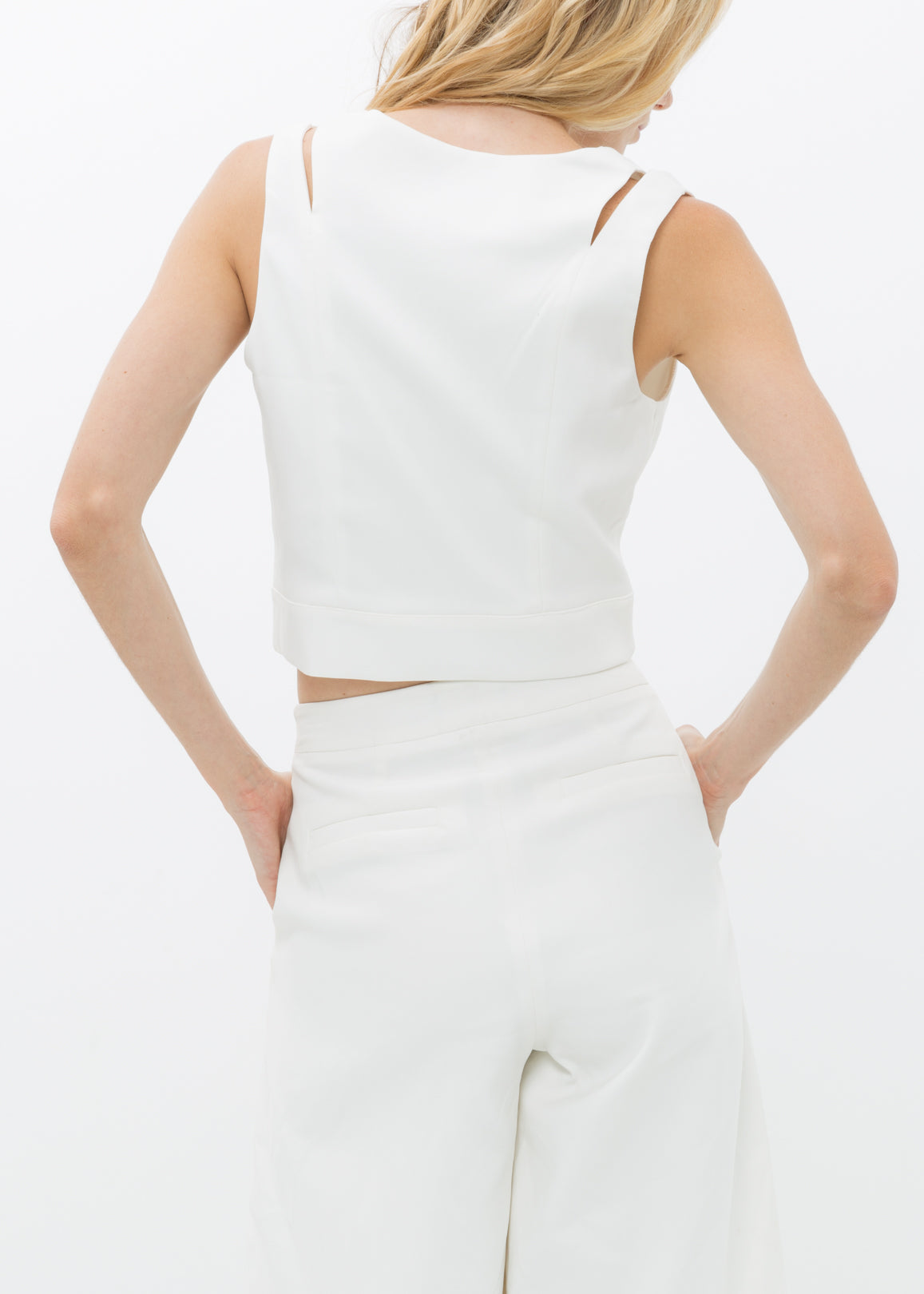 White V-neck sleeveless cropped top by Lemon Hera, featuring a fitted design and soft fabric for a stylish summer look.