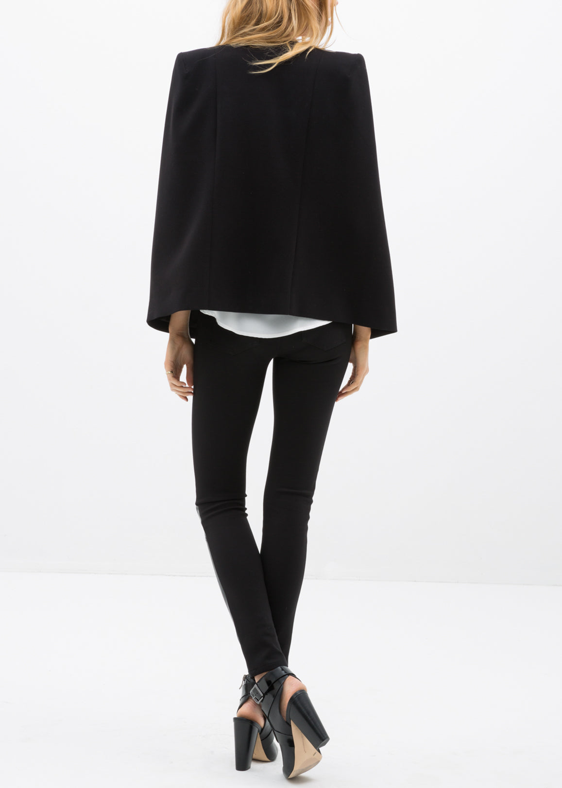 Black leather contrast skinny pants by Lemon Hera, showing close-up detail of fitted pants with contrasting side panels.