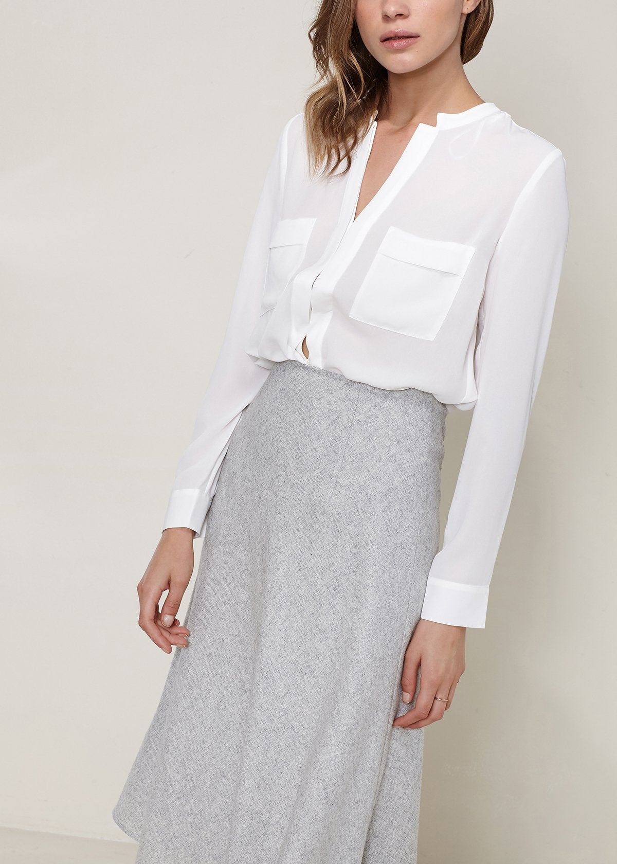 Heather grey high-waisted wool knit midi skirt by Lemon Hera, styled on a model showcasing its fit and texture.