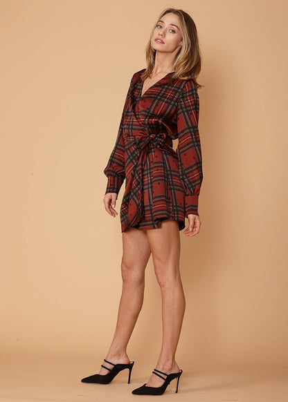 Lemon Hera plaid-polkadot mini wrap dress in brick fabric, featuring a fitted bodice and flowy skirt, displayed on a hanger.