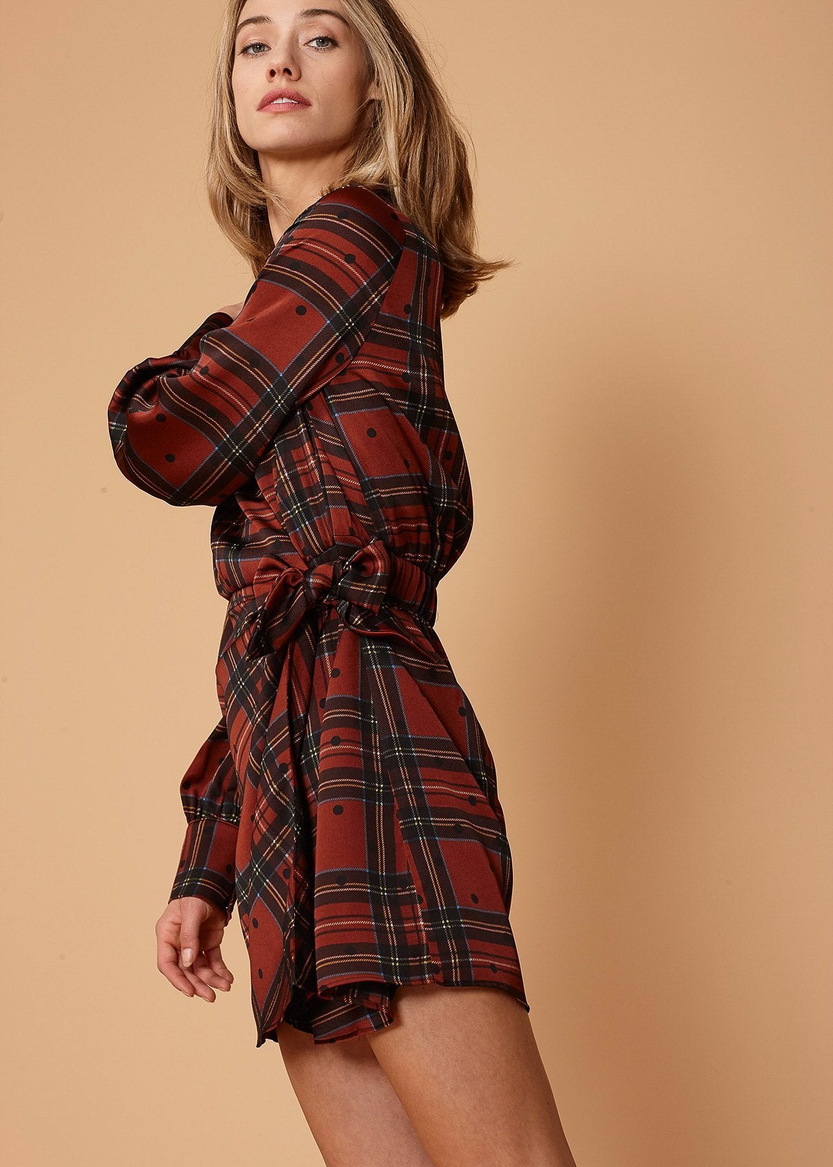 Lemon Hera plaid-polkadot mini wrap dress in brick color, featuring a stylish design with a fitted waist and long sleeves.