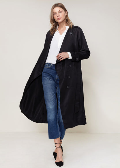 Black Ro &amp; De tie waist maxi trench coat by Lemon Hera, shown hanging with collar and long sleeves visible.