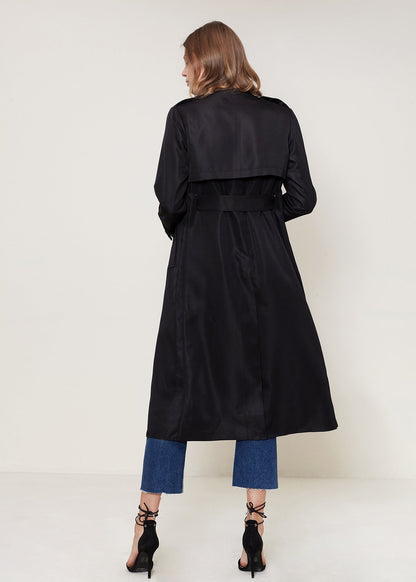 Black Ro &amp; De Tie Waist Maxi Trench Coat by Lemon Hera, shown on a model with long sleeves and a waist tie detail.
