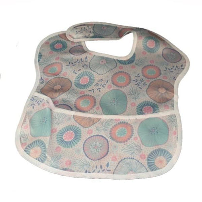 Pink and blue paisley waterproof baby bib with crumb catcher from Raspberry Pallas, made of denim-style material.
