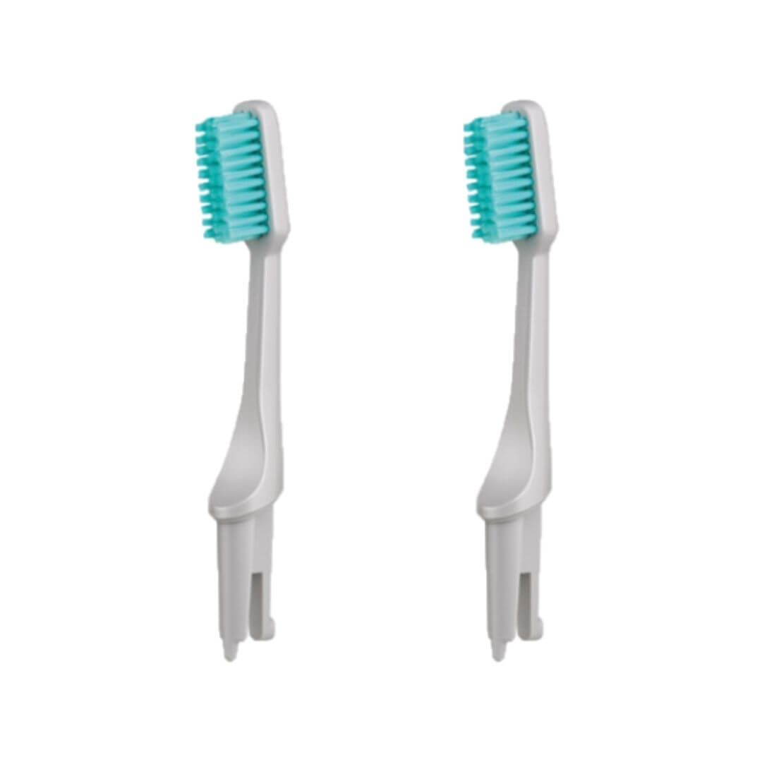 Two Gray Hestia sustainable toothbrush replacement heads with medium Kiesel bristles on white plastic bases.