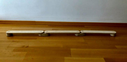 Circular wooden balance beam set from Red Oceanus, showcasing smooth round wooden beams arranged for stability and balance exercises.