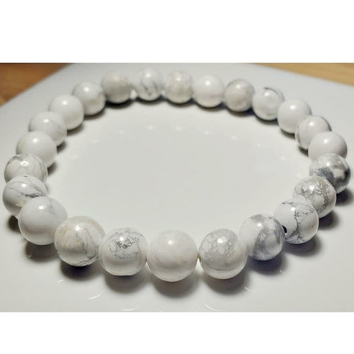8mm white howlite beaded elastic stretch bracelet by Silver Hestia, showcasing smooth white gemstone beads on a flexible elastic band.
