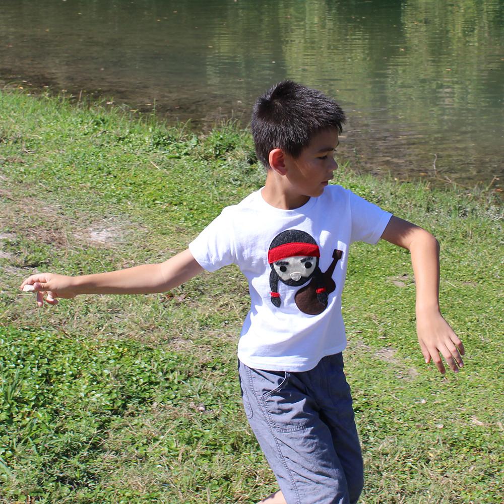 Kids T-shirt by Sky Blue Milo featuring Willie the Music Man design with a rock throw illustration on the front.