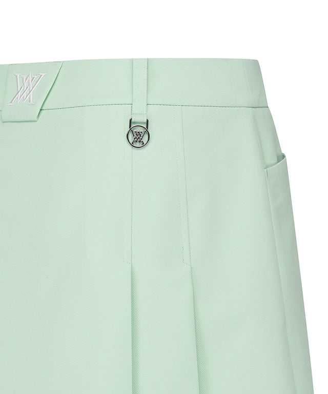 Light green women’s golf skirt with half pleats and under-line details by Amethyst Lucy, styled for active or casual wear.