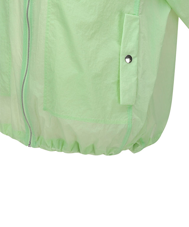 Light green women’s Stingray Fit jacket with shirring details by Amethyst Lucy, styled as a golf accessory.