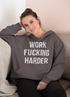 Black hoodie from Scorpius with bold "Work Fucking Harder" graphic, casual fit, and comfortable fabric.