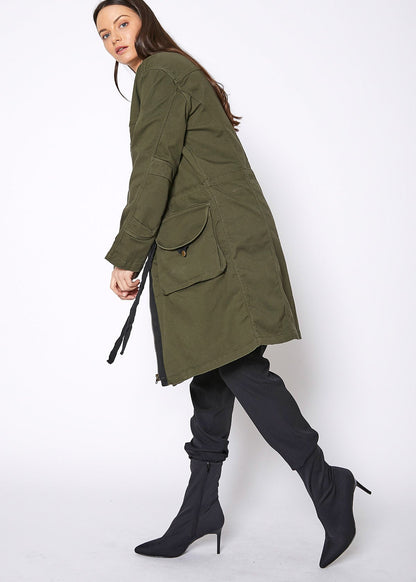 Women’s olive green zip-up long utility jacket by Lemon Hera, showing front view with multiple pockets and adjustable waist.