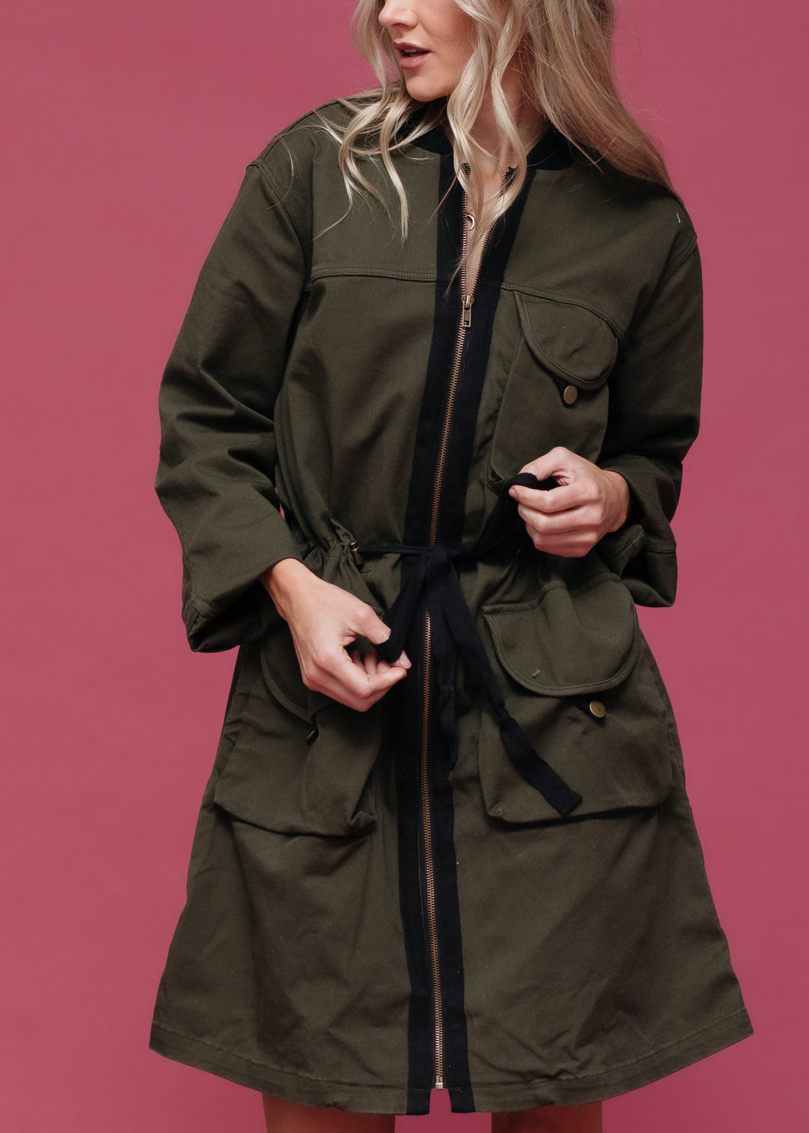 Women’s olive green zip-up long utility jacket by Lemon Hera, featuring multiple pockets and a stylish, functional design.