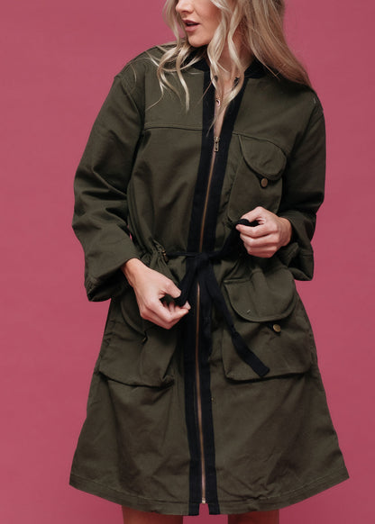 Women’s olive green zip-up long utility jacket by Lemon Hera, featuring multiple pockets and a stylish, functional design.