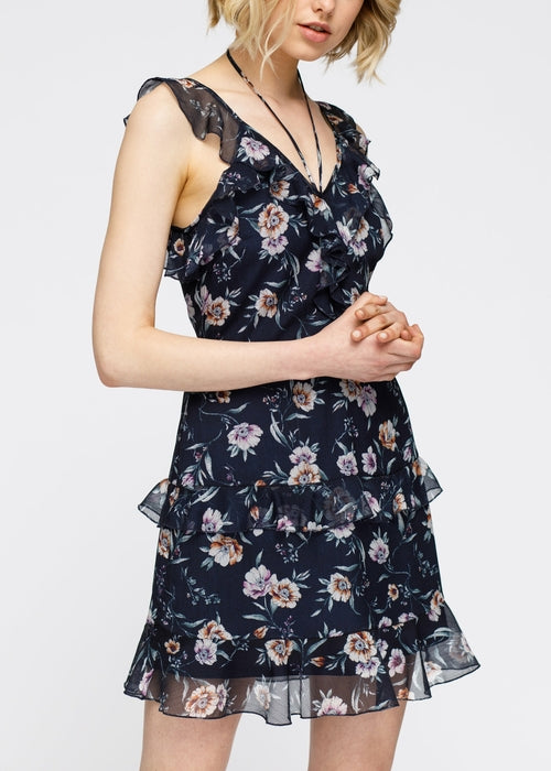 Navy wax flower mini ruffled sleeveless dress by Lemon Hera, featuring a fitted bodice and playful ruffle details.