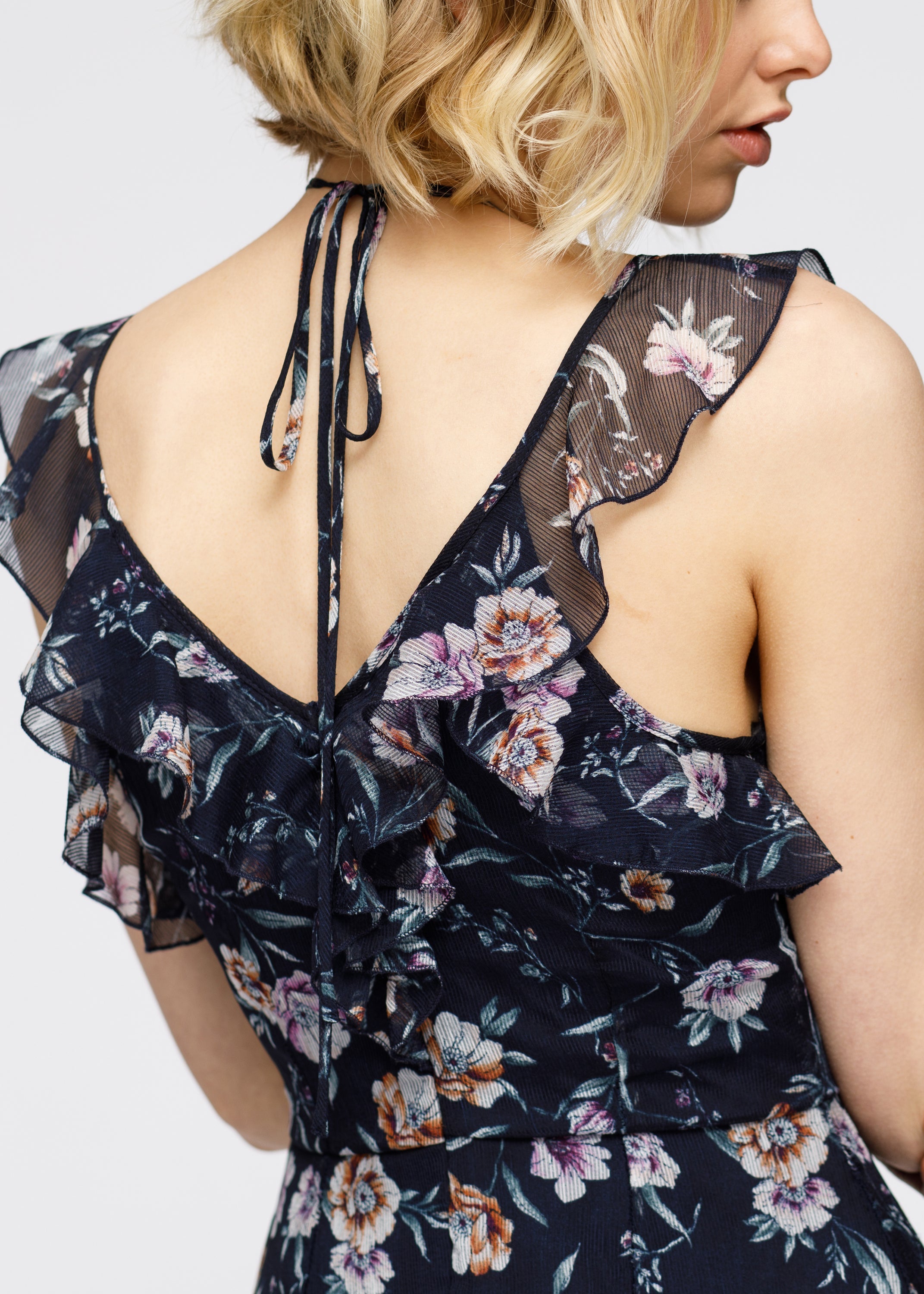 Navy Wax Flower Mini Ruffled Sleeveless Dress by Lemon Hera featuring a stylish sleeveless design and floral details.