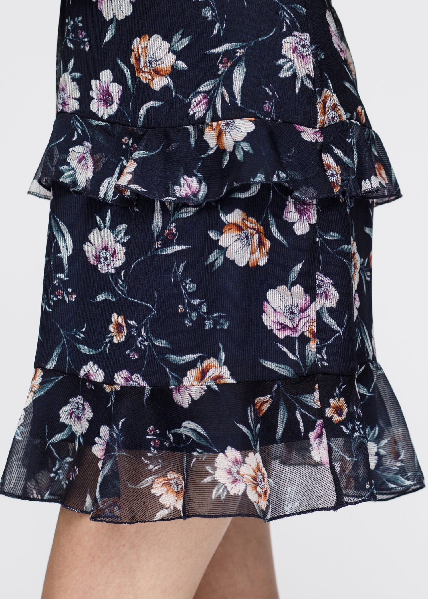 Navy wax flower mini ruffled sleeveless dress by Lemon Hera, showing the dress&