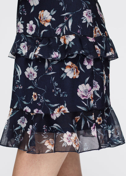 Navy wax flower mini ruffled sleeveless dress by Lemon Hera, showing the dress&