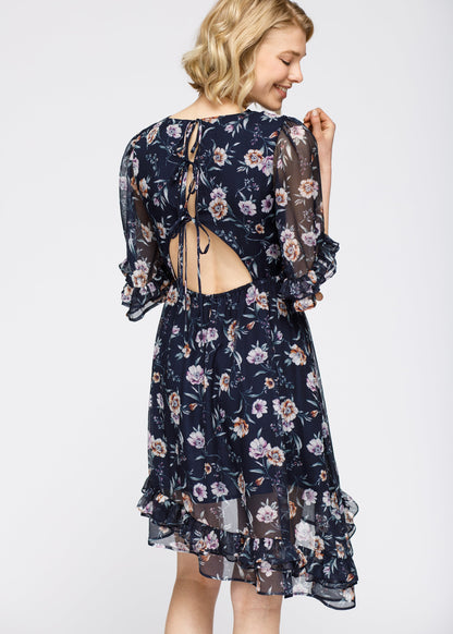 Navy wax flower asymmetrical hi-lo dress by Lemon Hera, lightweight fabric with floral pattern and flowing silhouette.