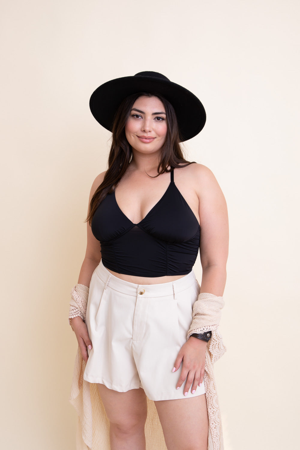 Black ruched bralette tank top by Periwinkle Aether, showcasing a fitted design with ruched detailing.