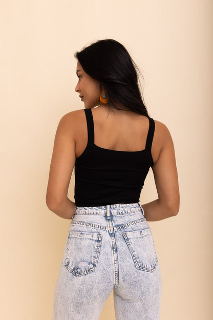 Black seamless brami top from Periwinkle Aether with a sleek, fitted design, perfect for layering or casual wear.