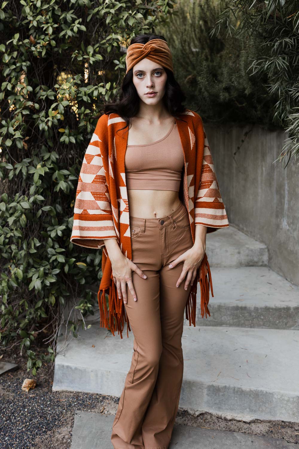 Periwinkle Aether Aztec Luxe fringed ruana in warm bronzer tones, showcasing intricate patterns and soft fringe detailing.