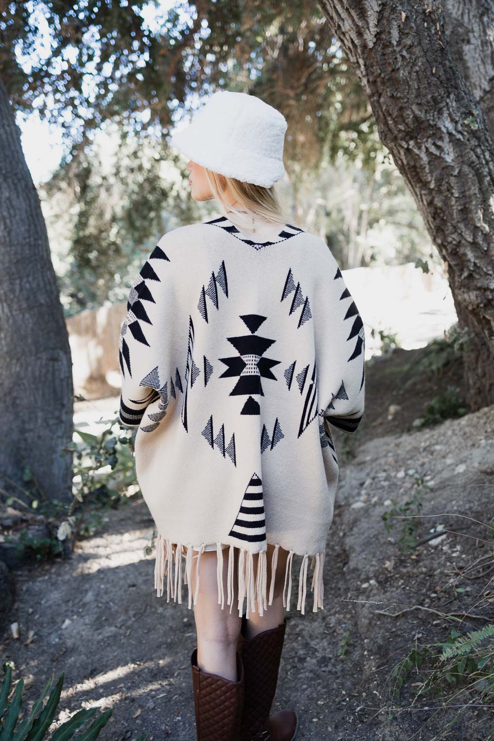 Natural color Aztec Luxe fringed ruana by Periwinkle Aether, showcasing intricate Aztec patterns and fringe detailing.