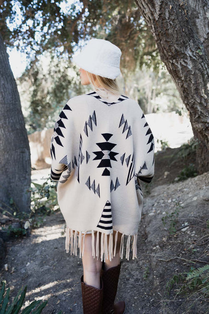 Natural color Aztec Luxe fringed ruana by Periwinkle Aether, showcasing intricate Aztec patterns and fringe detailing.