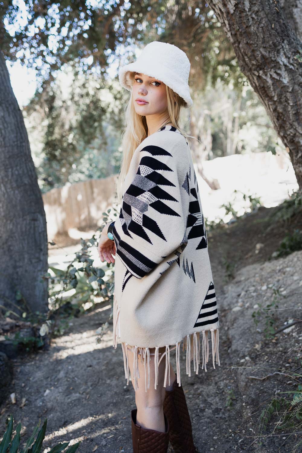 Natural Aztec Luxe fringed ruana accessory by Periwinkle Aether, featuring intricate patterns and soft fabric in neutral tones.