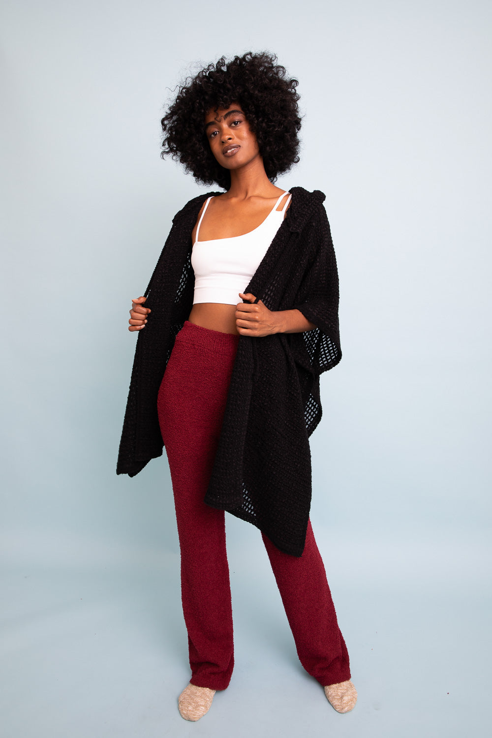Black cozy soft waffle hooded ruana from Periwinkle Aether, featuring a relaxed fit and plush fabric for warm, stylish layering.