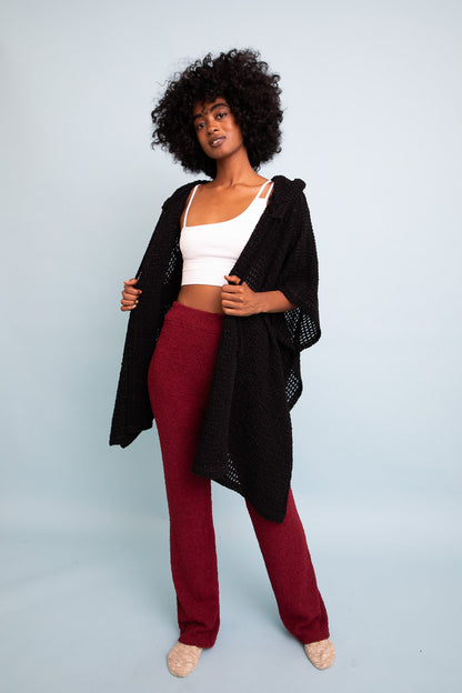 Black cozy soft waffle hooded ruana from Periwinkle Aether, featuring a relaxed fit and plush fabric for warm, stylish layering.