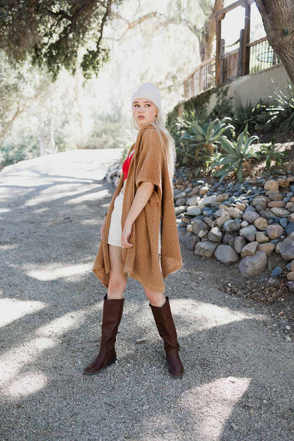 Camel-colored cozy soft waffle hooded ruana from Periwinkle Aether, featuring a textured waffle knit and relaxed fit.