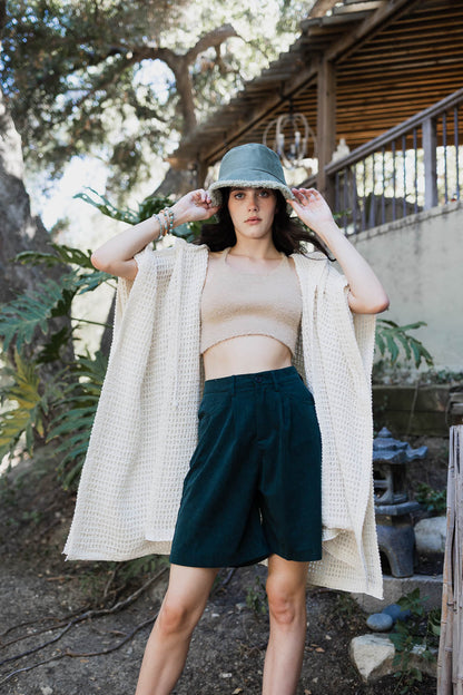 Ivory cozy soft waffle hooded ruana by Periwinkle Aether, lightweight accessories with a textured waffle knit design.