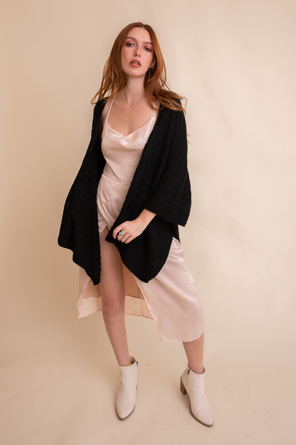 Black ridged rib knit ruana by Periwinkle Aether, stylish layering wrap with textured fabric and open front design.
