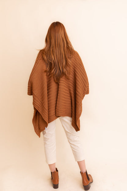 Camel-colored rib knit ruana by Periwinkle Aether, showcasing a stylish layered wrap with a textured, ridged design.