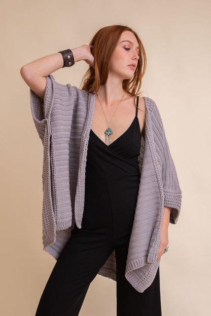 Gray ridged rib knit ruana, stylish layering wrap by Periwinkle Aether, draped fabric with textured ribbed pattern for cozy elegance.