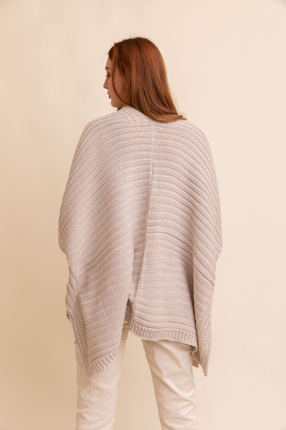 Periwinkle Aether ridged rib knit ruana, stylish layering wrap in soft oatmeal color, featuring textured ribbed design for cozy elegance.