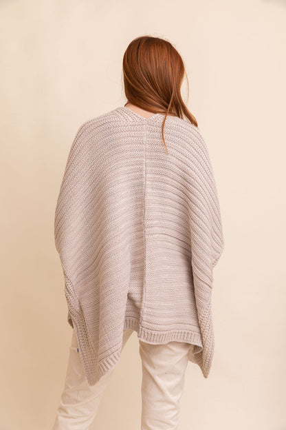 Rib knit ruana wrap from Periwinkle Aether featuring a ridged design, perfect for stylish layering and cozy accessories.