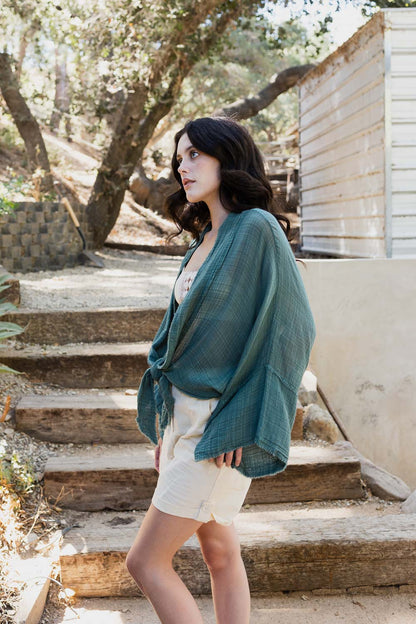 Periwinkle Aether Flounce Tie-Front Kimono Wrap accessory with flowing fabric and tie closure, shown in a stylish fashion image.