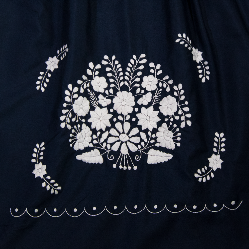 Navy blue Boho chic dress with white floral patterns for women, designed by Violet Athena, featuring a flowing, stylish silhouette.