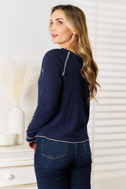 Carmine Juneberry Basic Bae long raglan sleeve round neck top displayed on a hanger, showing its casual style and soft fabric.