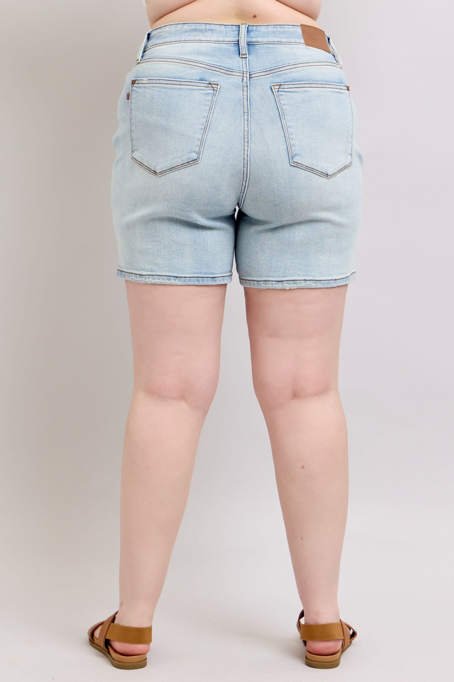 Judy Blue plus size denim shorts with two buttons and pockets, featuring a full size fit from Jade Icarus.