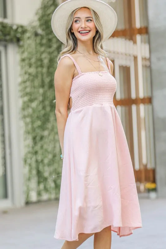 Jade Icarus smocking open-back sleeveless midi dress for women, showing a flowy black dress with a fitted smocked bodice and open back design.