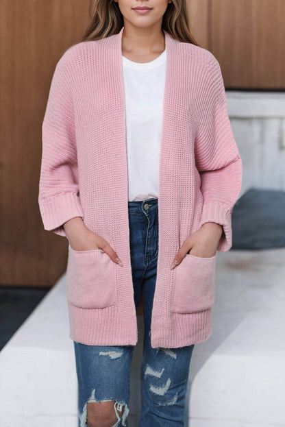 Pink oversized fold-over sleeve open-front cardigan by Carmine Juneberry, showing soft knit fabric and relaxed fit.