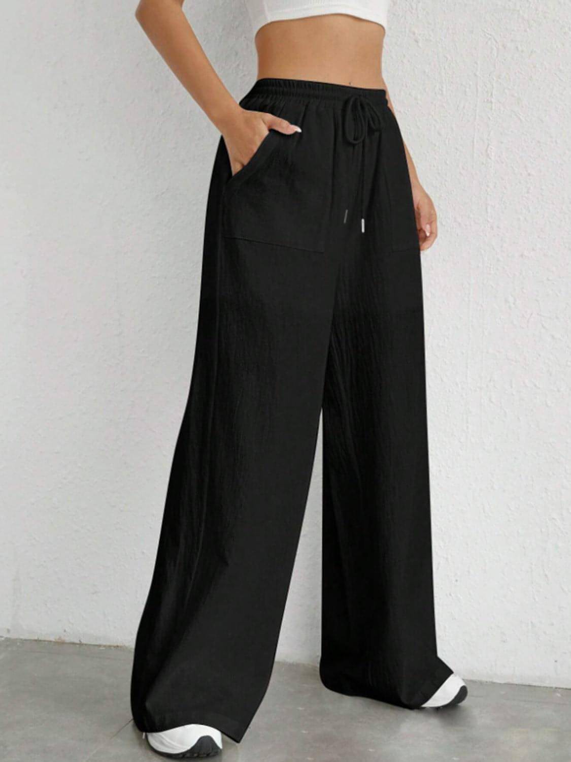 Carmine Juneberry drawstring wide-leg pants in a relaxed fit, featuring a high waist and flowing fabric.