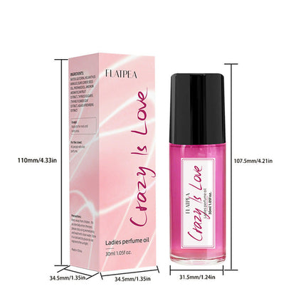 Carmine Juneberry Crazy In Love™ ball perfume oil for women, featuring a sleek bottle with a decorative cap and floral accents.